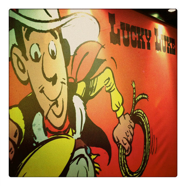 Curio & Co. looks at popular Franco-Belgian cowboy comic book Lucky Luke. Photo of Lucky Luke Banner. Curio and Co. www.curioandco.com