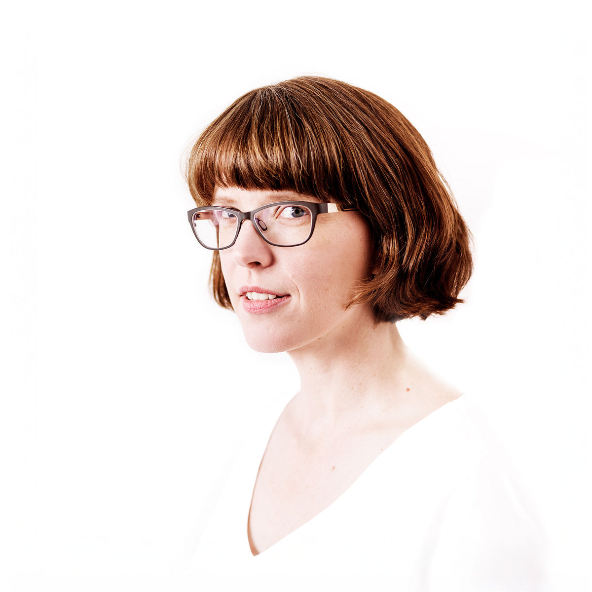 Kirstie Shepherd portrait with bob hair and slight smile on white background