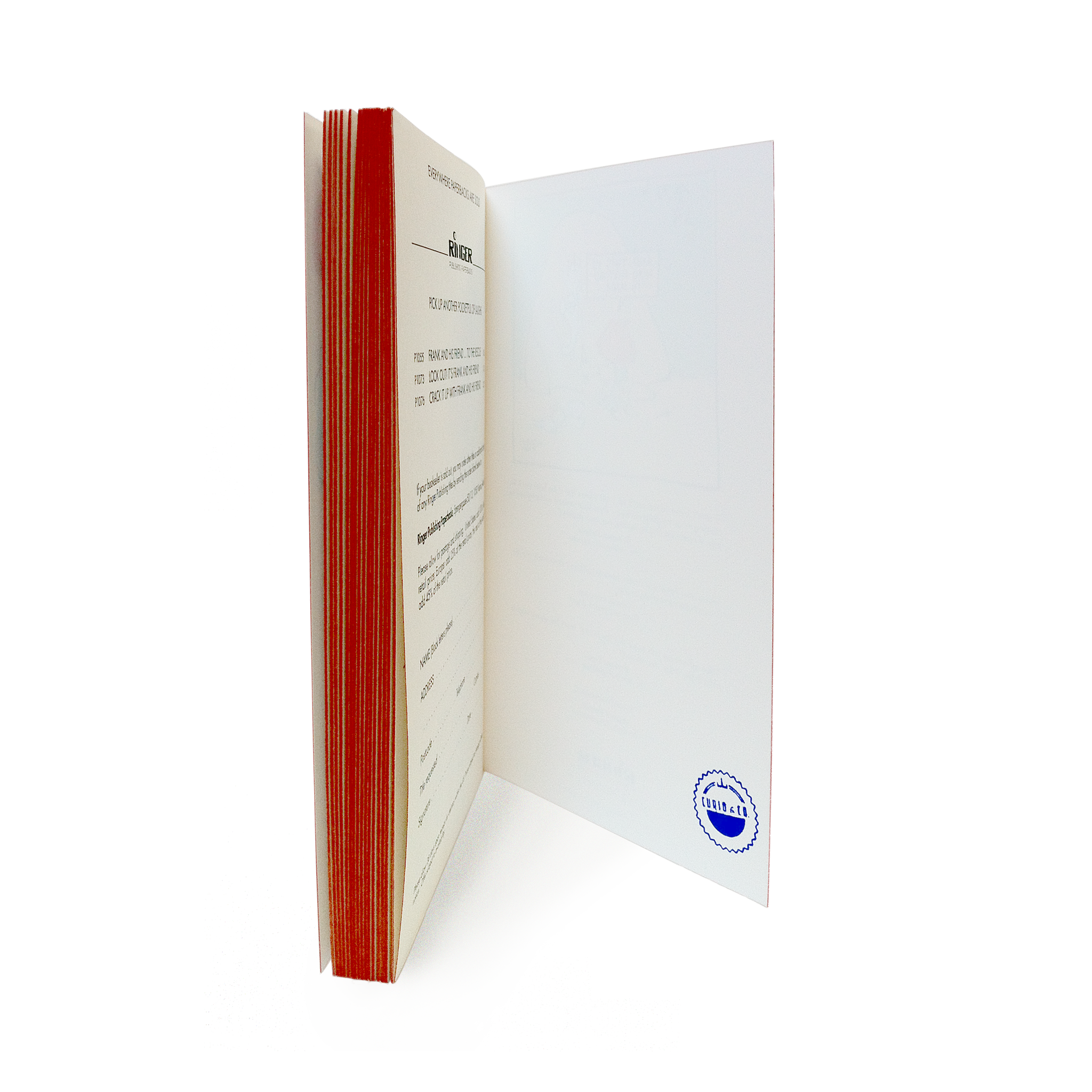 Paperback book with red color edges showing the Curio and Co.  stamp on back cover 