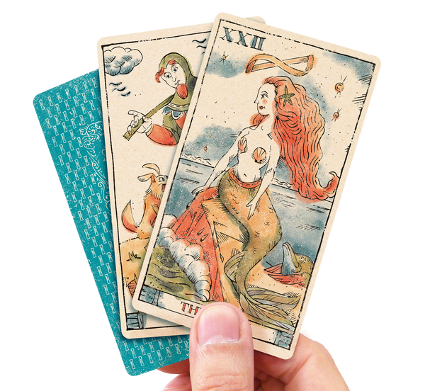 Three Tarot of Musterberg cards held by man's hand back of cards and Fool and Siren cards facing up.