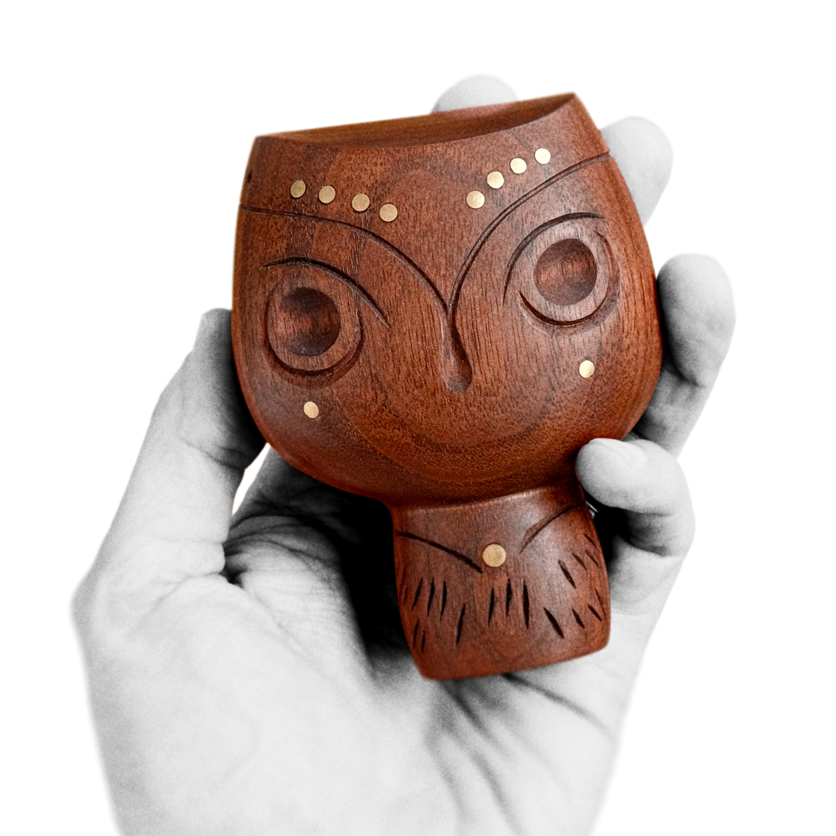 Hand holding black walnut chocolate brown mid-century design style owl figure with soft, round, and polished surfaces and additional brass inlay about 10 cm heigh