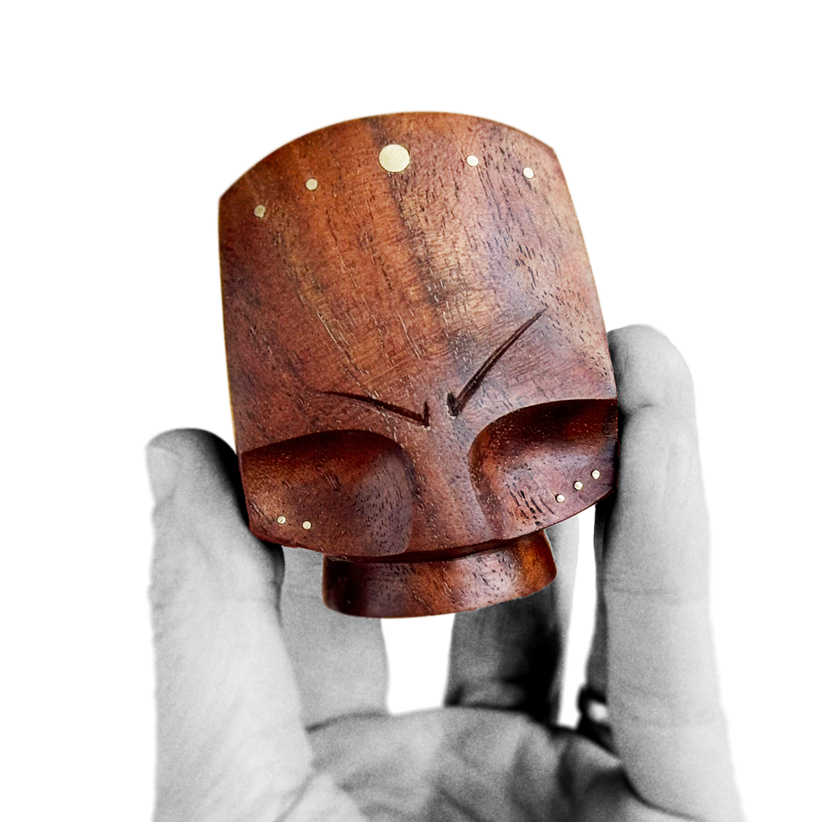 Hand holding black walnut chocolate brown mid-century design style of blocky figure head with brass inlay about 6 cm heigh