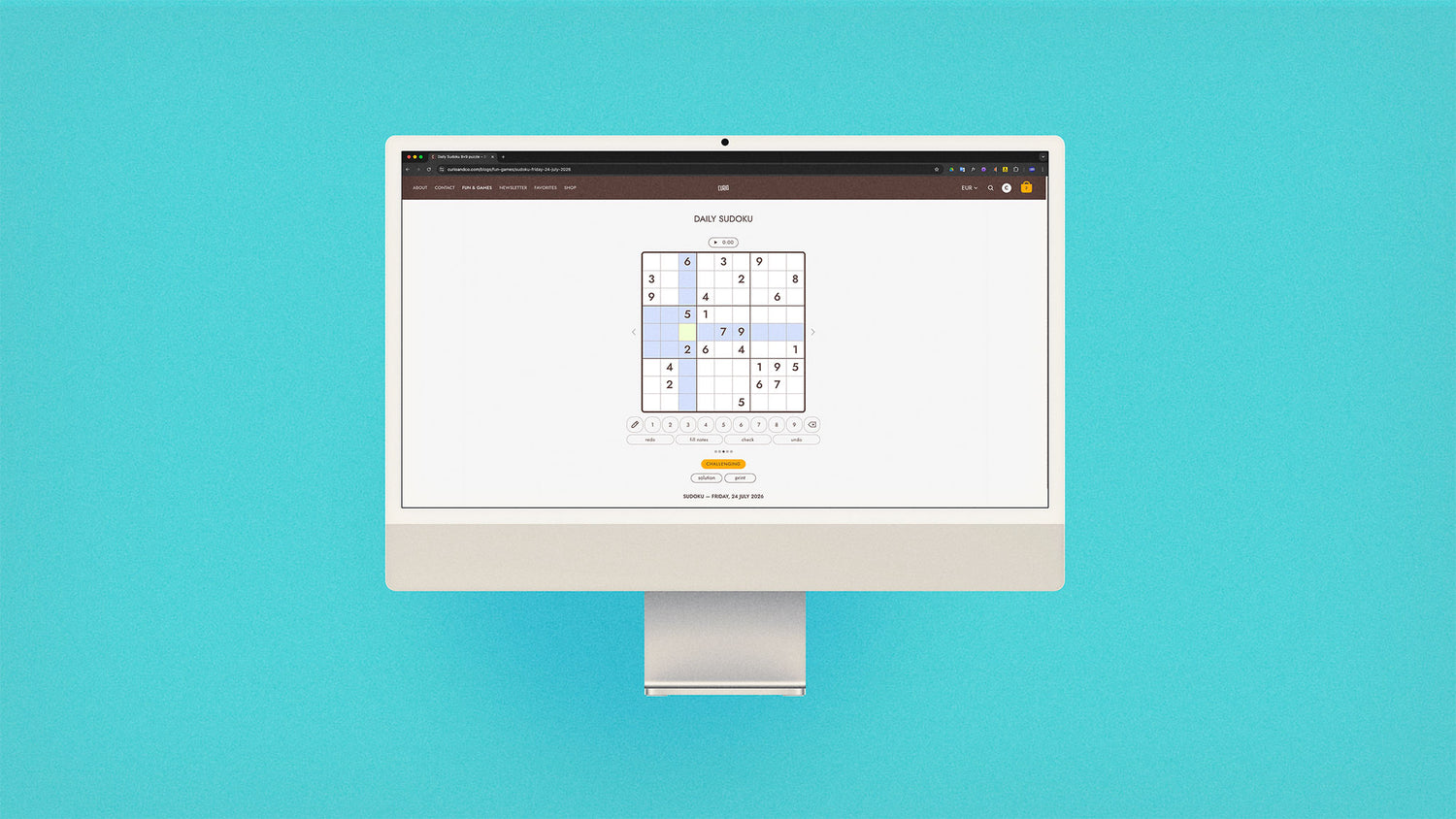 iMac with screen on curioandco.com's interactive daily sudoku puzzle for July 24, 2026 . Photo on aqua background
