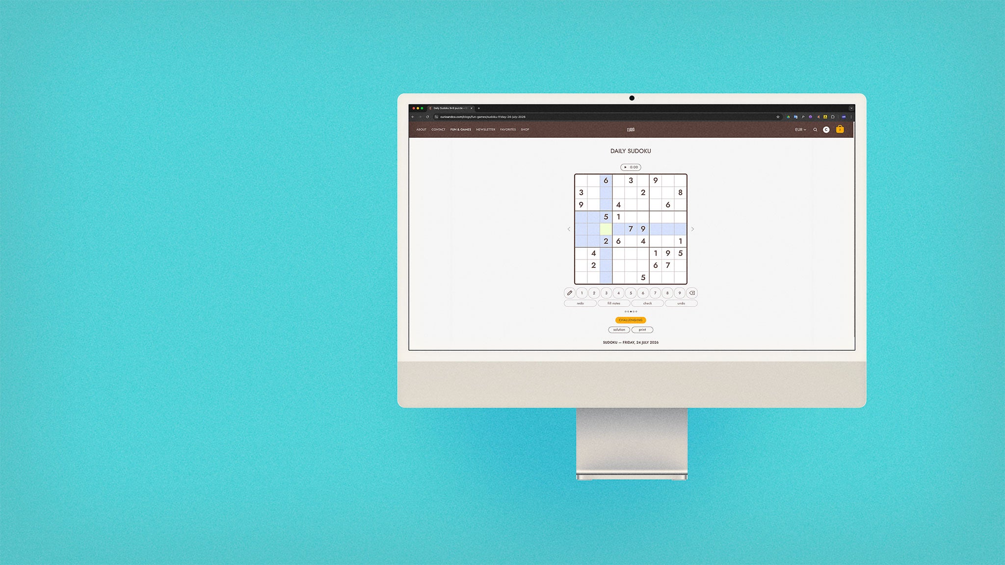 iMac sitting on the right, with browser screen on curioandco.com's interactive daily sudoku puzzle for July 24, 2026. Computer on aqua background.