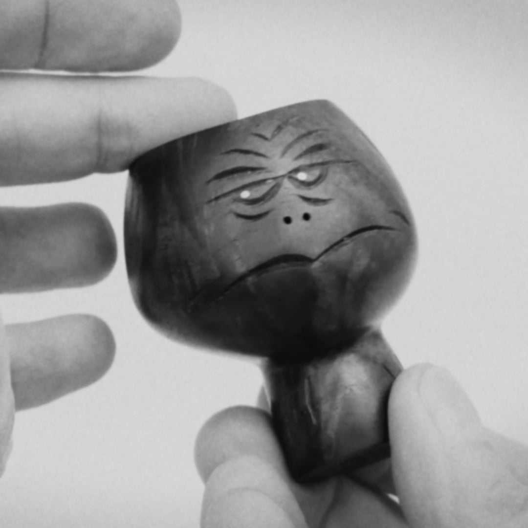 1:1 Black and white video clip of hands showing black walnut wood sculpture of  abstracted head figure mid-century style about 8cm high