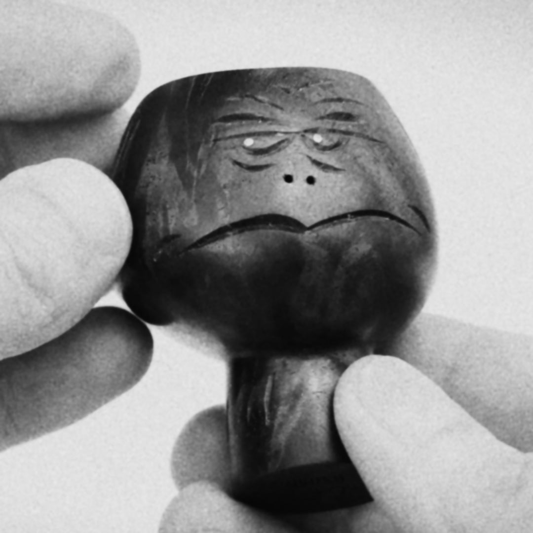 1:1 Black and white video clip of hands showing black walnut wood sculpture of  abstracted head figure mid-century style about 8cm high
